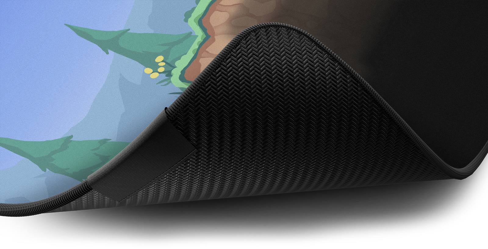 Close-up of the stitched edge and non-slip rubber base of the Hystar Overworld deskmat