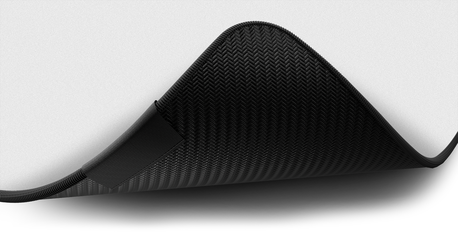 Close-up of the stitched edge and non-slip rubber base of the Hystar Classic deskmat in White. White XXL (36" x 16"), White XXXL (45" x 20")
