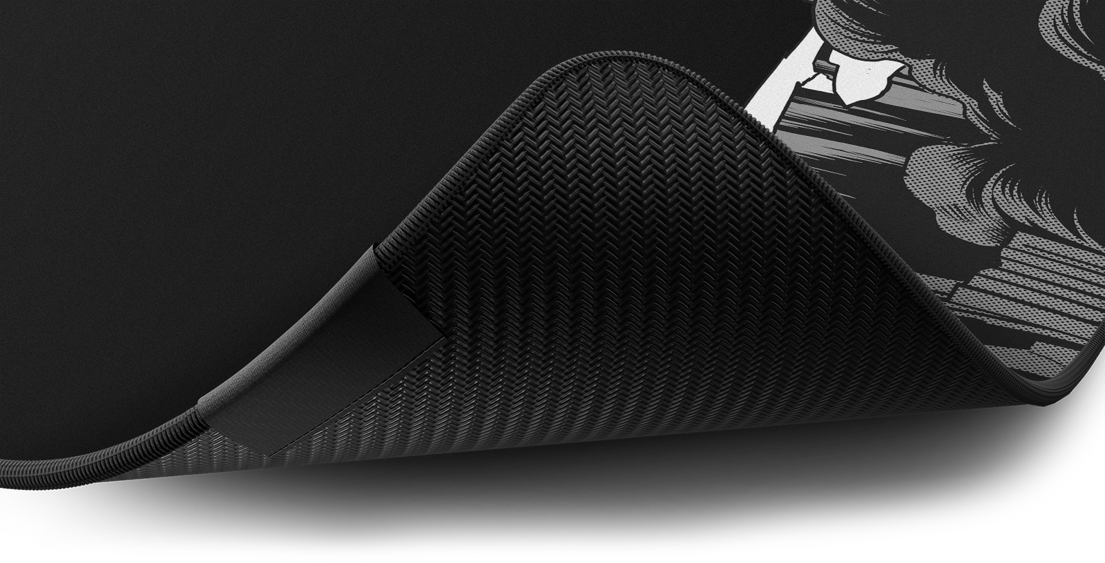 Close-up of the stitched edge and non-slip rubber base of the Hystar Death deskmat