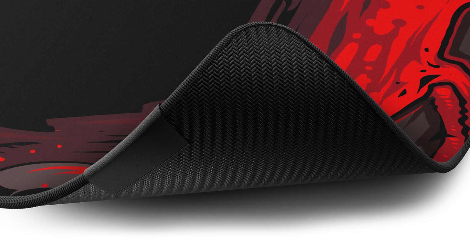 Close-up of the stitched edge and non-slip rubber base of the Hystar Cerberus deskmat