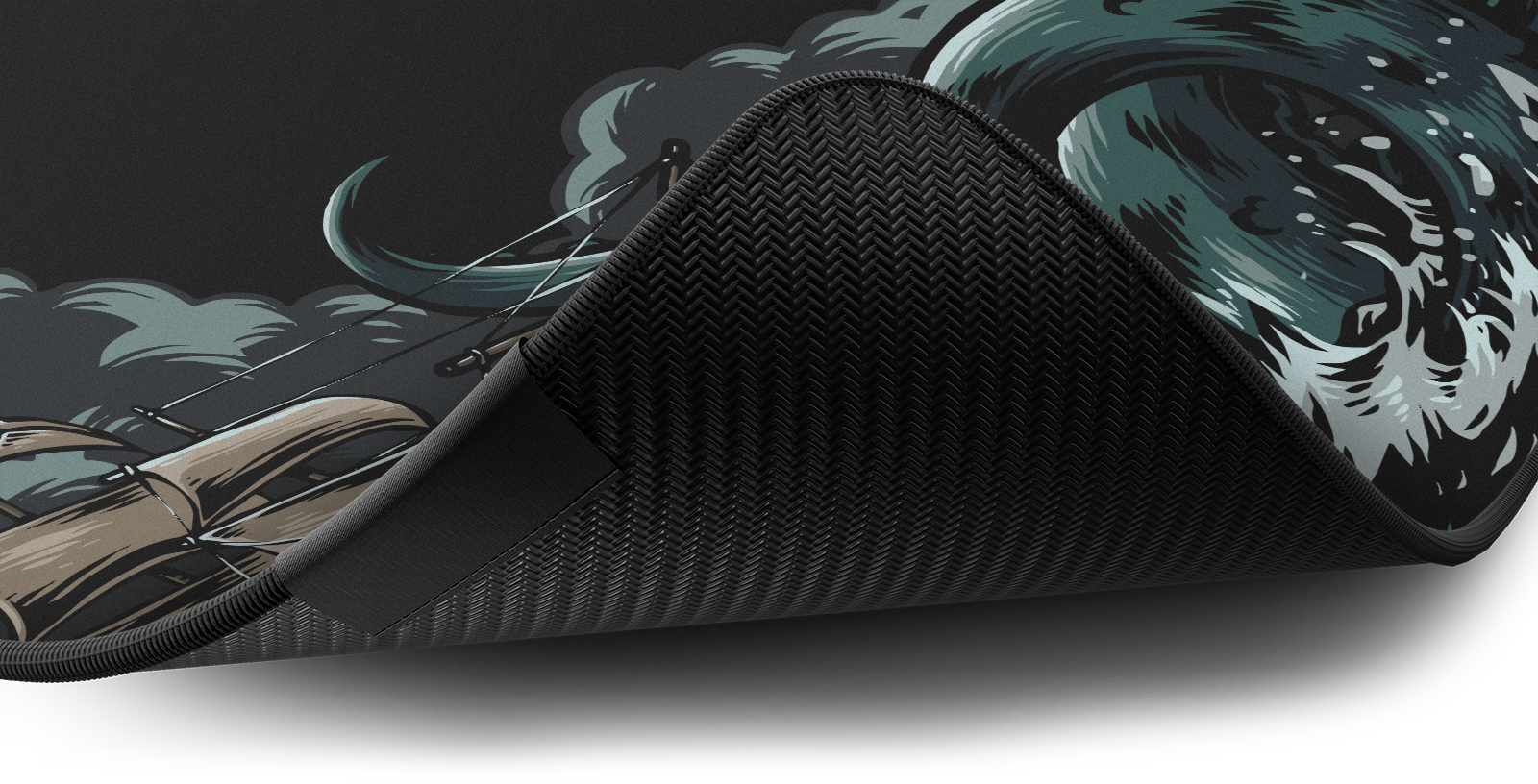 Close-up of the stitched edge and non-slip rubber base of the Hystar Kraken deskmat
