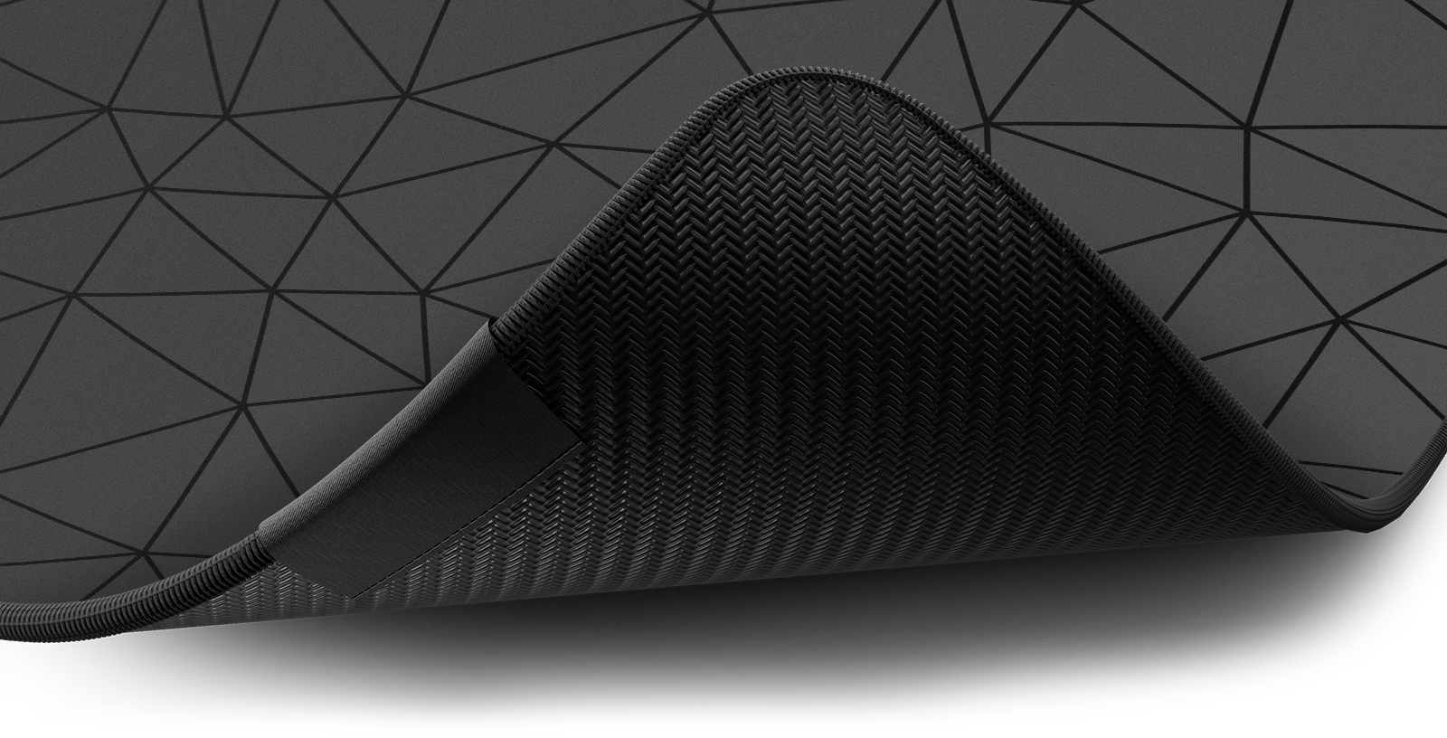 Close-up of the stitched edge and non-slip rubber base of the Hystar Poly deskmat in Black. Black XXL (36" x 16"), Black XXXL (45" x 20")